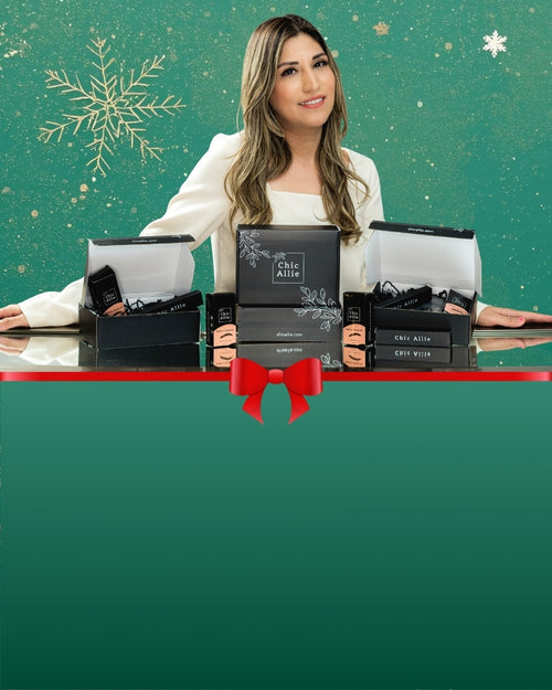 Woman holding black gift boxes with Chic Allie Cosmetics branding against a green background with snowflake decorations.